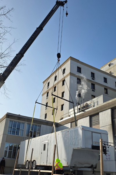 Mobile kitchen trailer being positioned by crane at Crowne Plaza Fredericton